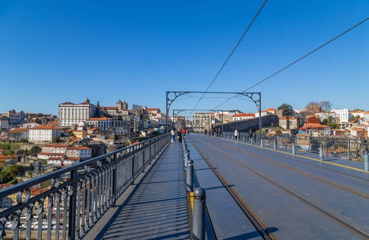 Porto, Portugal - March 02, 2023: View of Ribeira historical quarter on the margin Douro river embankment in the old town and Luis I bridge, Porto, Portugal.