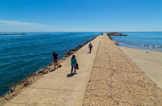 Algarve, Portugal: 14 April 2022: People walking at the port in Algarve, Portugal