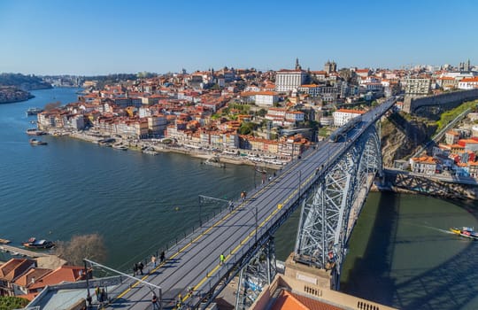 Porto, Portugal - March 02, 2023: View of Ribeira historical quarter on the margin Douro river embankment in the old town and Luis I bridge, Porto, Portugal.