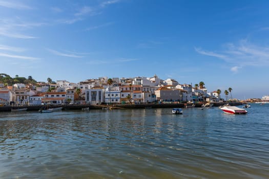 Ferragudo, Portugal - August 25, 2022 - View of the white town with boats moored in the foreground, Ferragudo, Algarve, Portugal, Europe