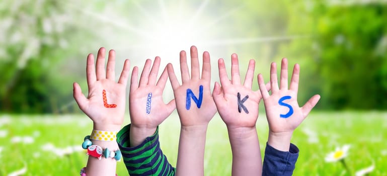 Children Hands Building Colorful English Word Links. Sunny Green Grass Meadow As Background.