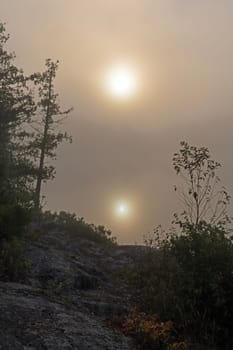 Sun Reflection in Early Morning Fog on Jenny Lake in the Boundary Waters Canoe Area in Minnesota