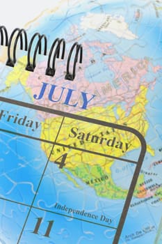 Calendar page showing 4th of July American Independence day on globe background