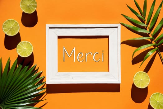 Flat Lay With French Text Merci Means Thank You. Orange Background With Picture Frame And Tropical Lemon And Palm Leaf.