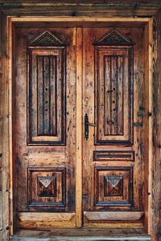 Old rustic wooden door. Entrance to house. Wooden background