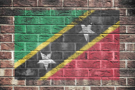 A St Kitts-Nevis flag on old brick wall background