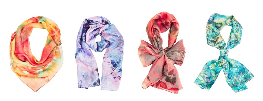 Silk colourful hand painted tied scarves on white background. Woman fashion, tying a scarf, wearing a scarves. Stylish ways to tie and wear scarves