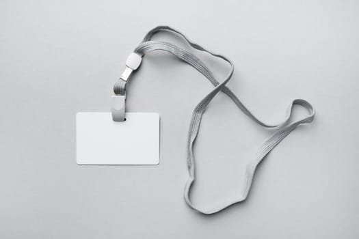 Blank plastic badge and lanyard mockup. Empty name tag mock up. Space for text. Flat lay.