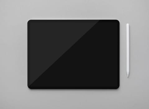 Mockup of tablet computer with blank black screen and stylus on gray paper background. Top view. Flat lay.