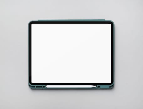 Photo of modern touch tablet with blank white screen and stylus on gray paper background. Modern work tools of designer. Flat lay.