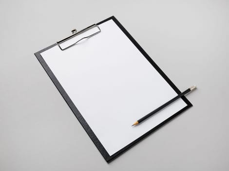 Blank letterhead, clipboard and pencil on gray paper background. Responsive design template.