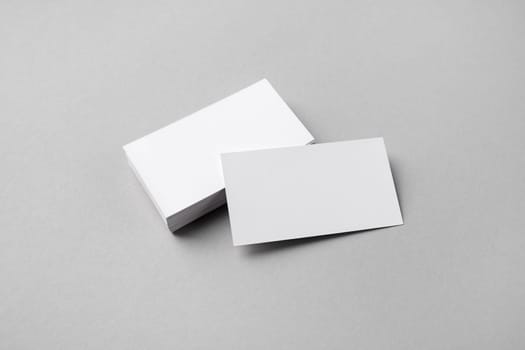 Blank business cards mockup on gray paper background. Copy space for text.