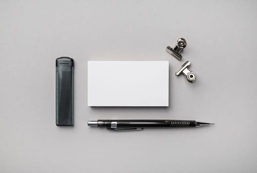Blank stationery set on gray paper background. Brand identity mockup. Flat lay.