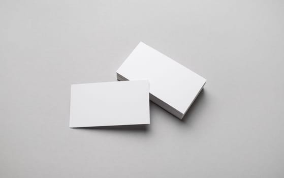 Photo of blank business cards on gray paper background. Template for ID.