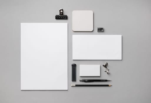Blank corporate identity template. Photo of blank stationery set on gray paper background. Flat lay.