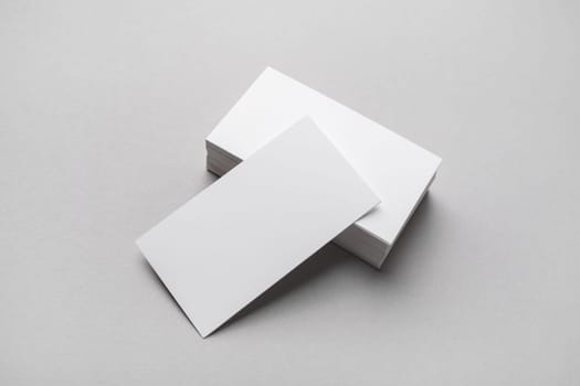 Blank business cards on gray paper background. Mockup for branding identity.