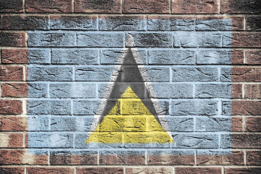 A St Lucia flag on old brick wall background