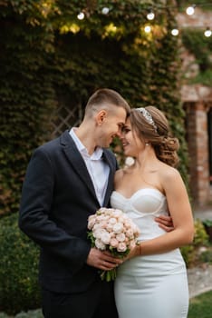 portrait of a young couple of bride and groom on their wedding day in a country cottage