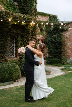 portrait of a young couple of bride and groom on their wedding day in a country cottage