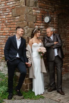 portrait of a young couple of bride and groom on their wedding day in a country cottage