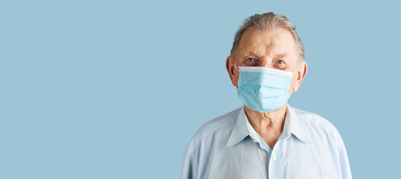 Old aged senior male patient with face mask. Wearing coronavirus covid-19 protection medical mask during the pandemic