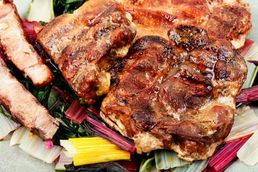Appetizing roast meat steak with a vegetable garnish. Copy space.