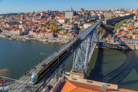 Porto, Portugal - March 02, 2023: View of Ribeira historical quarter on the margin Douro river embankment in the old town and Luis I bridge, Porto, Portugal.