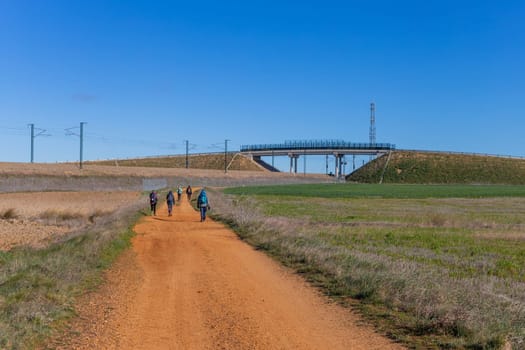 Navarre, Spain, 26 March, 2023: Pilgrims walk along the Camino De Santiago, the Way of St. James pilgrimage route, Navarra, Spain.
