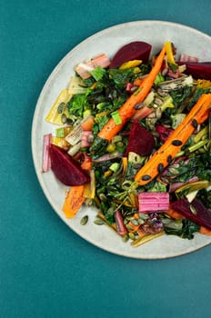 Healthy diet food- stewed chard leaves, beets and carrots. Organic food. Flat lay