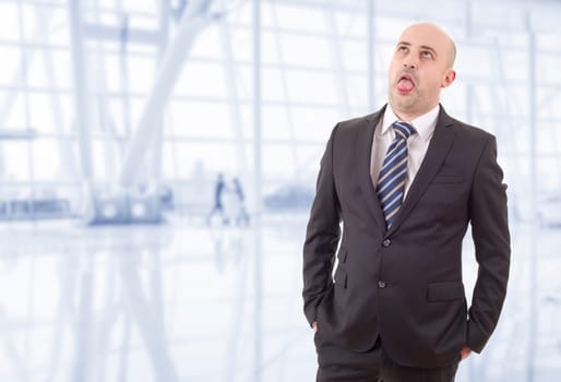 tired businessman in a suit looking up, at the office