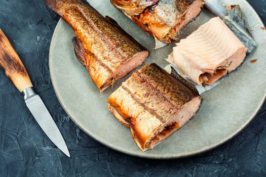 Tasty hot smoked trout salmon with beer