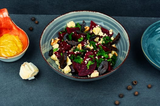 Diet salad of beets, nuts and cheese in bowl.