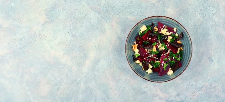 Dietary salad of beetroot, cheese, prunes and nuts. Copy space, recipe place.