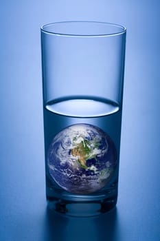 An image of the earth in a glass of water.