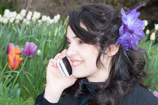 beautiful smile of a girl on the phone in a beautiful day