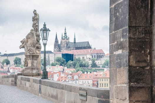 karlov bridge in a cloudy day and Prague Castle