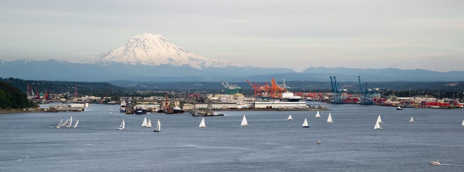 An evening boat race is conducted on the waters of Puget Sound Tacoma Washington