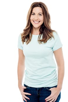 Happy woman standing with hands in pockets
