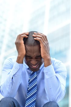 Frustrated businessman sitting in office steps