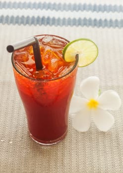 Ice lemon tea in glass with white flower