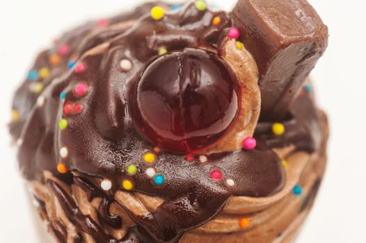 Chocolate cream cake with red jelly on white background, Selective focus