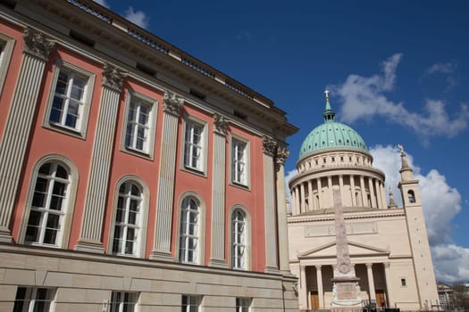 Nikolaikirche with obelisk next to the newly built city castle in Potsdam