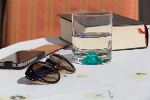 Still life with glasses,glass,book and smartphone