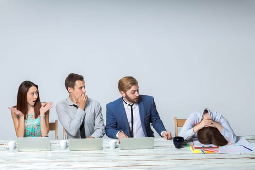 Business team working on their business project together at office on light gray background.  Everyone is wondering, boss sleeping. copyspace image.