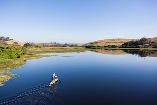 Blue lagoon rural river water paddler board  coastline scenic landscape