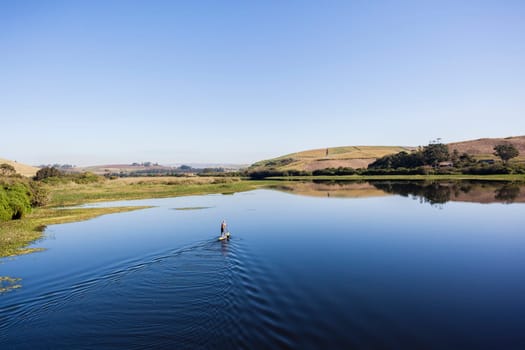 Blue lagoon rural river water paddler board  coastline scenic landscape