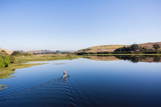 Blue lagoon rural river water paddler board  coastline scenic landscape