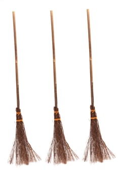Three witches broomsticks isolated on a white background