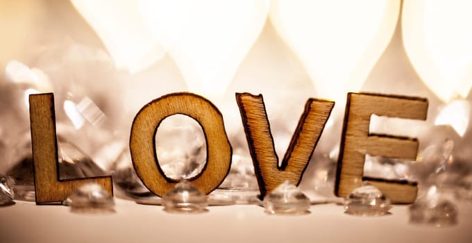 Romantic love word in wooden letters and diamonds