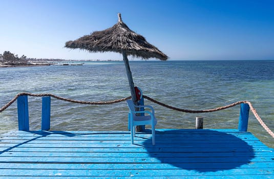 the parasol by the blue sea